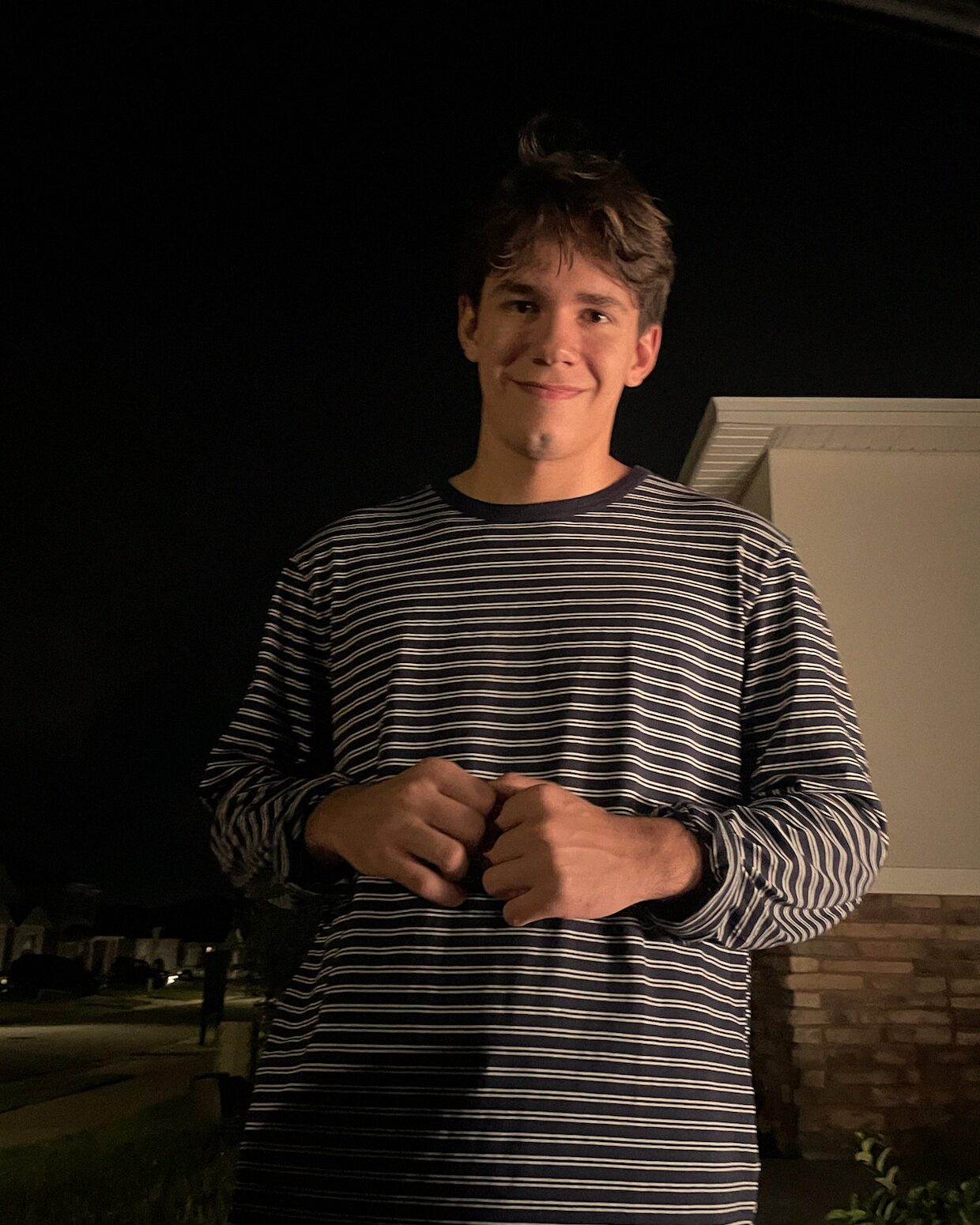 Matheus Camargo smiling in a striped shirt